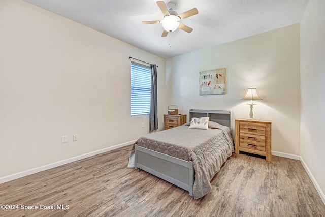 bedroom with wood-type flooring and ceiling fan