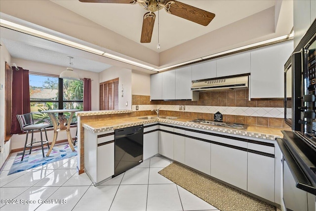 kitchen featuring decorative backsplash, white cabinets, light tile patterned floors, extractor fan, and dishwasher