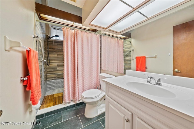 bathroom with vanity, curtained shower, toilet, and tile patterned floors