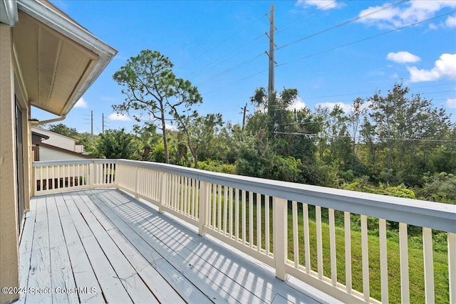 wooden terrace featuring a yard