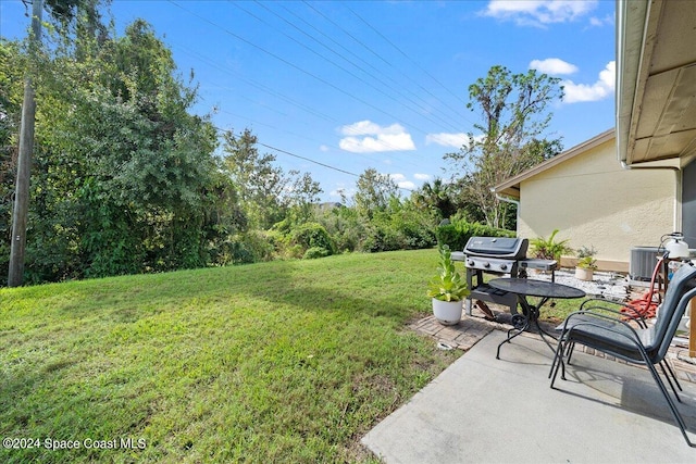 view of yard featuring a patio and central AC unit