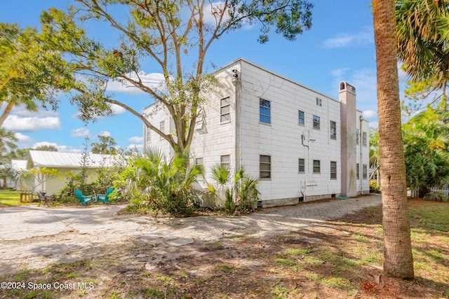 415 Audubon Dr, Melbourne, FL 32901 - view of property exterior featuring a chimney