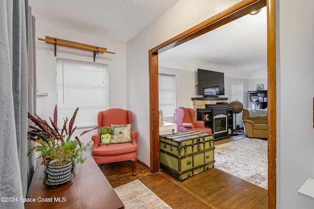 sitting room with hardwood / wood-style flooring and a fireplace