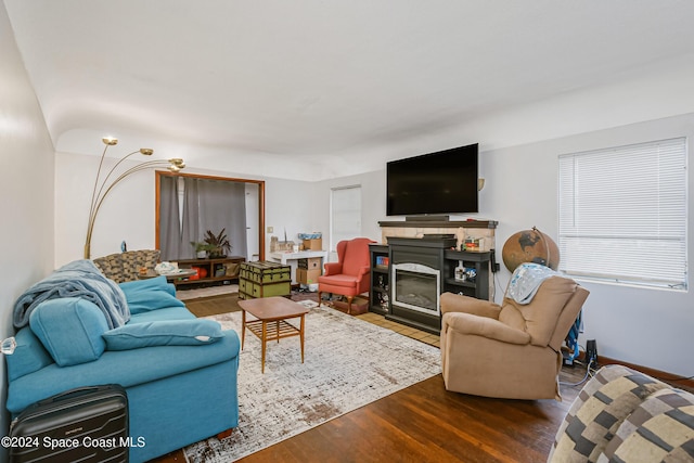 415 Audubon Dr, Melbourne, FL 32901 - living area featuring wood finished floors, a glass covered fireplace, and baseboards