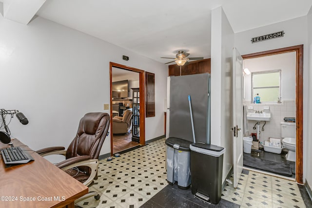 office featuring tile walls and ceiling fan