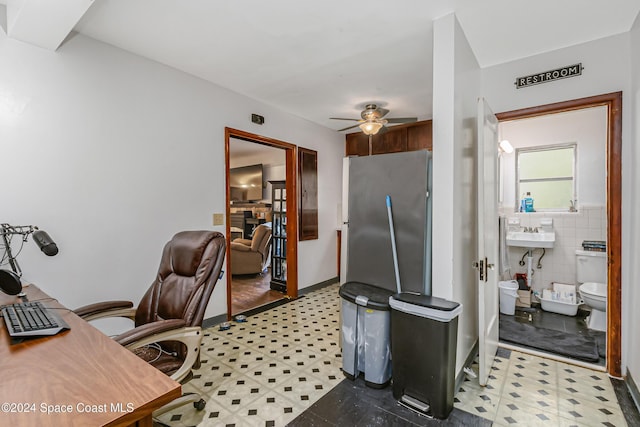 415 Audubon Dr, Melbourne, FL 32901 - office area with light flooring, a ceiling fan, a sink, and tile walls