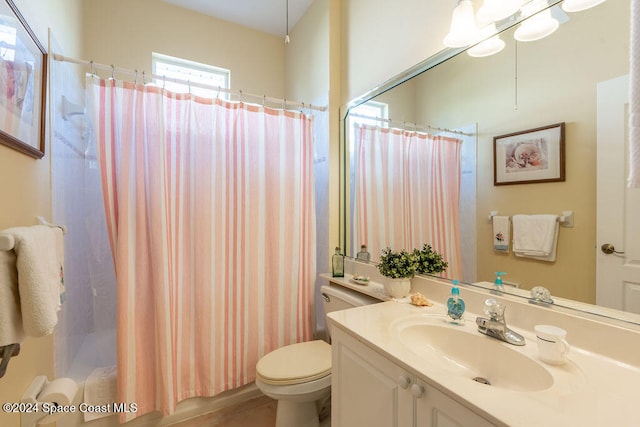 bathroom featuring vanity, toilet, and walk in shower