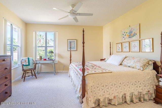 bedroom featuring light carpet and ceiling fan