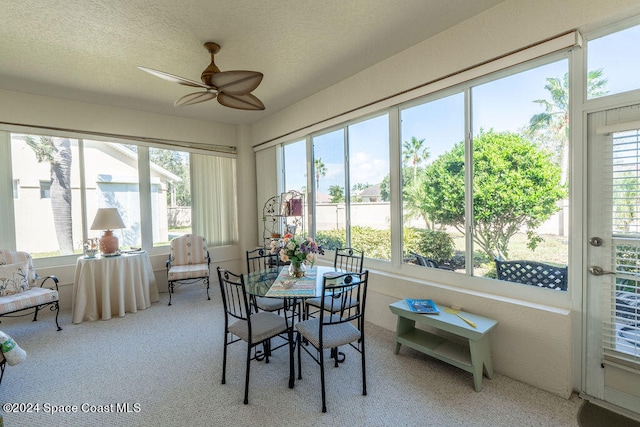 sunroom featuring ceiling fan