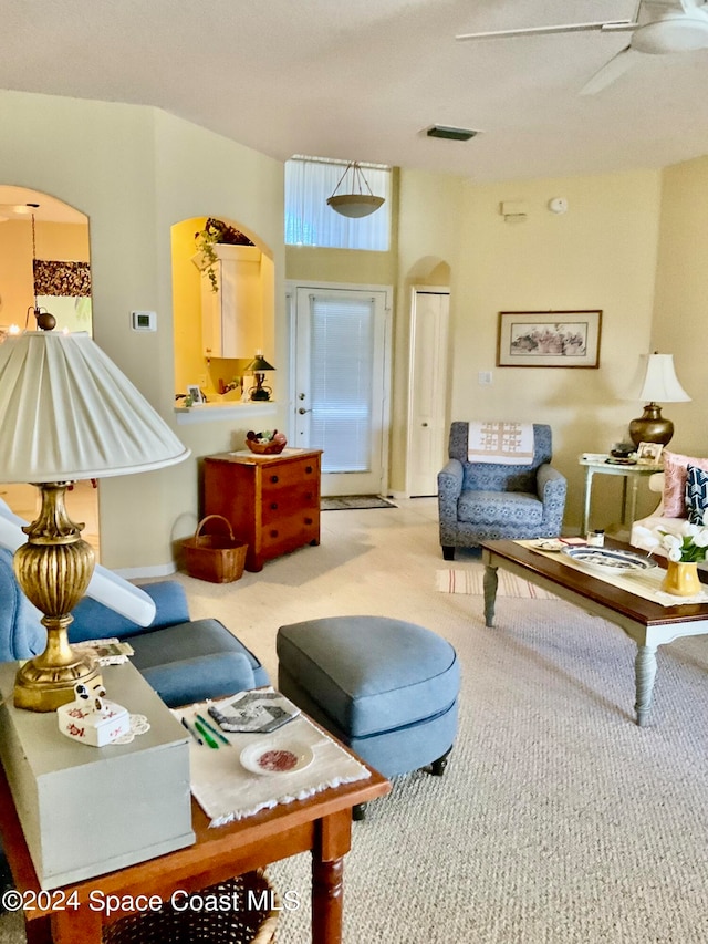 living room with light colored carpet and ceiling fan