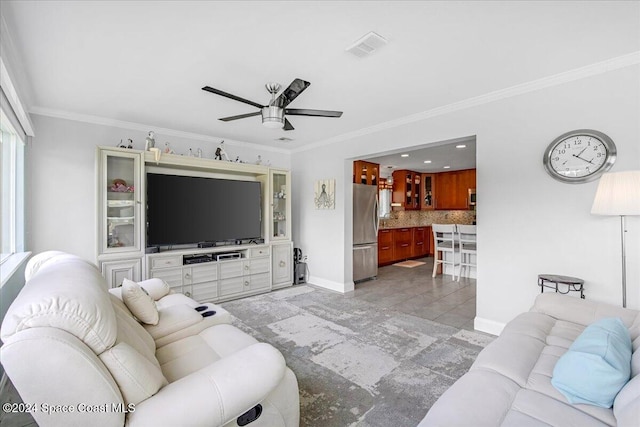 living room featuring ceiling fan and crown molding