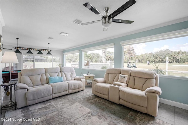 living room featuring tile patterned floors, ceiling fan, and ornamental molding