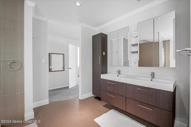 bathroom featuring tile patterned flooring, vanity, and crown molding