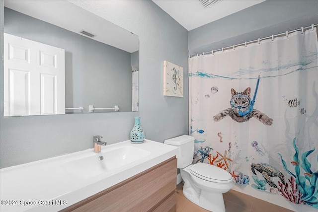 bathroom with tile patterned flooring, a shower with curtain, vanity, and toilet