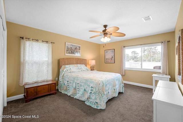 bedroom with dark carpet and ceiling fan