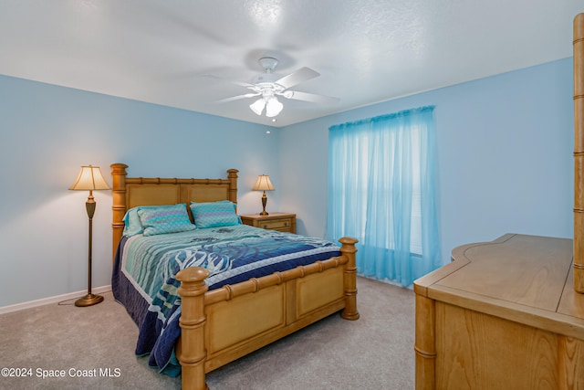 bedroom featuring light carpet and ceiling fan