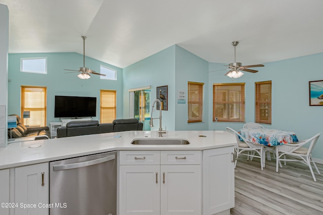 kitchen featuring sink, vaulted ceiling, stainless steel dishwasher, white cabinets, and light hardwood / wood-style floors