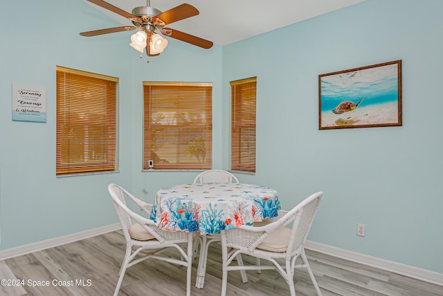 dining area with light hardwood / wood-style flooring and ceiling fan