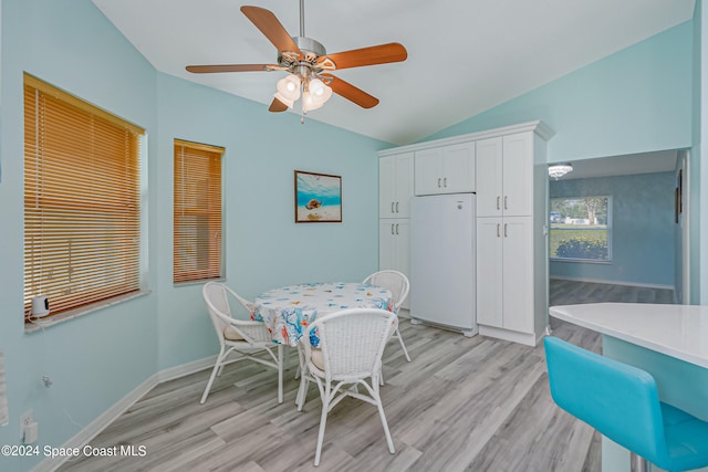 dining space featuring vaulted ceiling, light hardwood / wood-style flooring, and ceiling fan