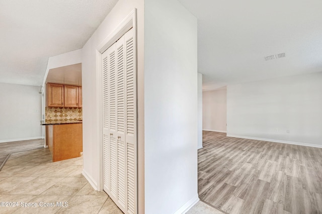 hall with light hardwood / wood-style floors