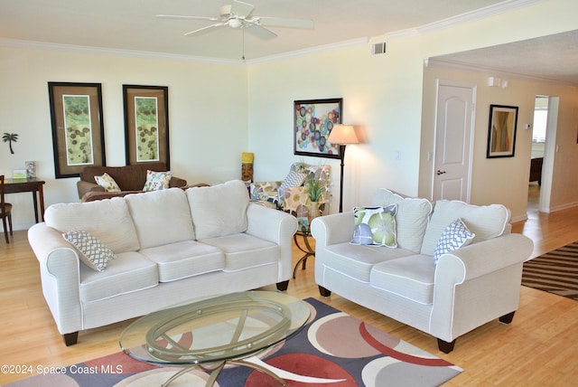 living room featuring ceiling fan, ornamental molding, and light hardwood / wood-style flooring