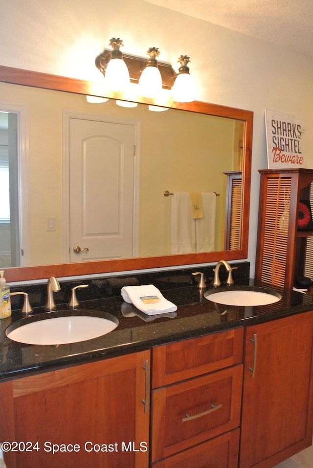bathroom with a sink and double vanity