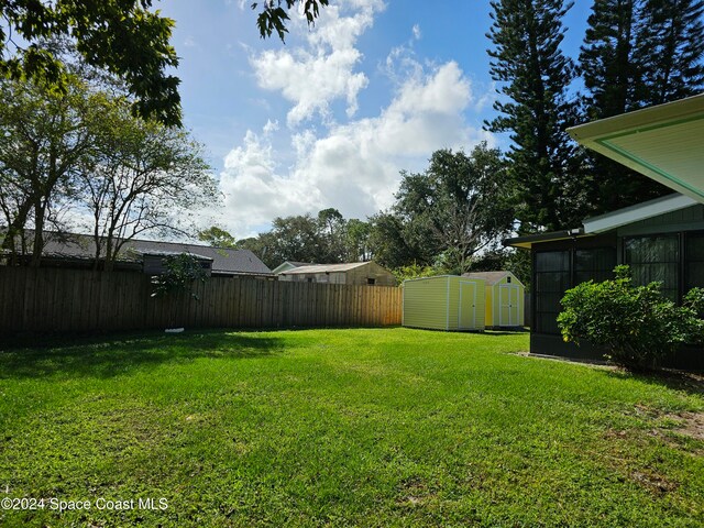 view of yard with a storage unit