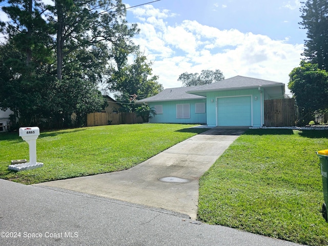 single story home featuring a front lawn and a garage