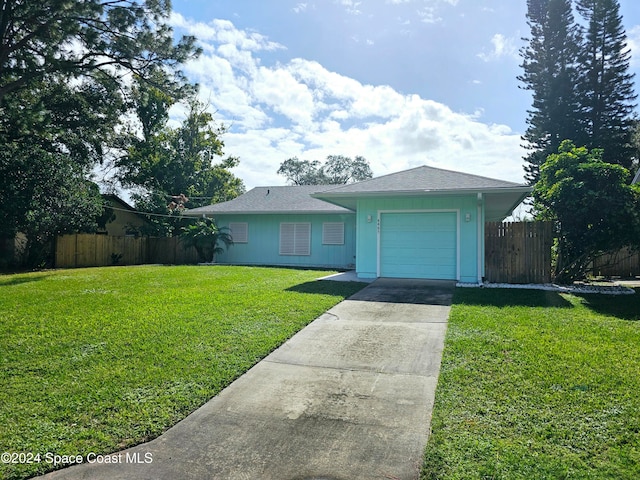 single story home with a garage and a front lawn