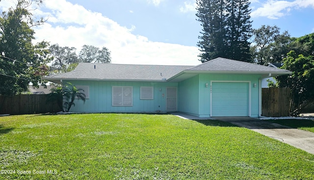 ranch-style home with a front yard and a garage