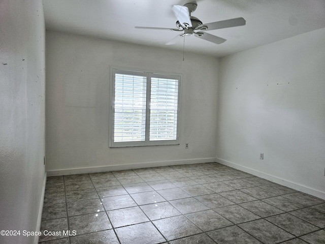 unfurnished room featuring tile patterned flooring and ceiling fan