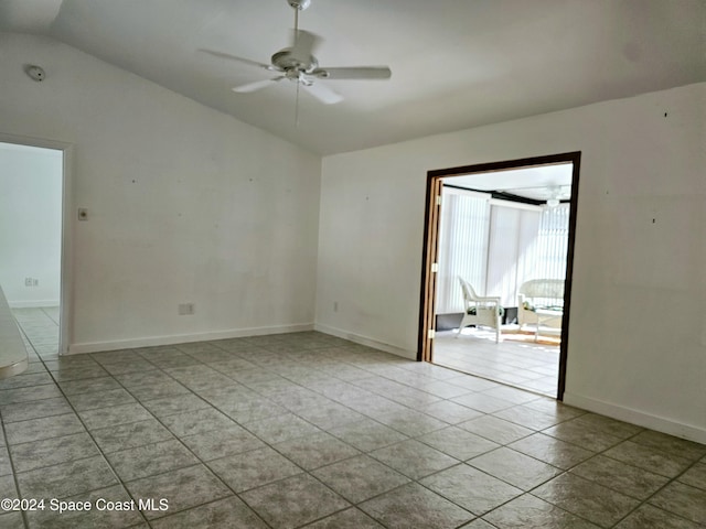 empty room featuring ceiling fan, light tile patterned floors, and lofted ceiling