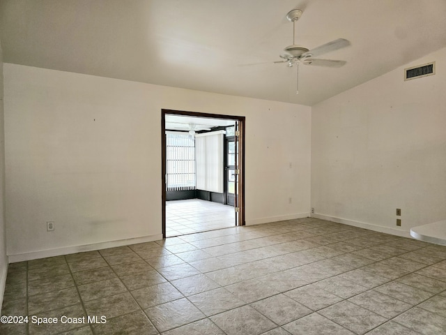 empty room featuring light tile patterned floors, ceiling fan, and lofted ceiling