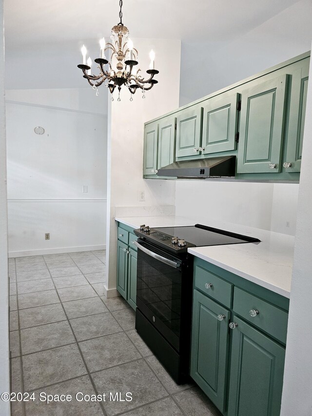 kitchen featuring electric range, decorative light fixtures, and green cabinetry