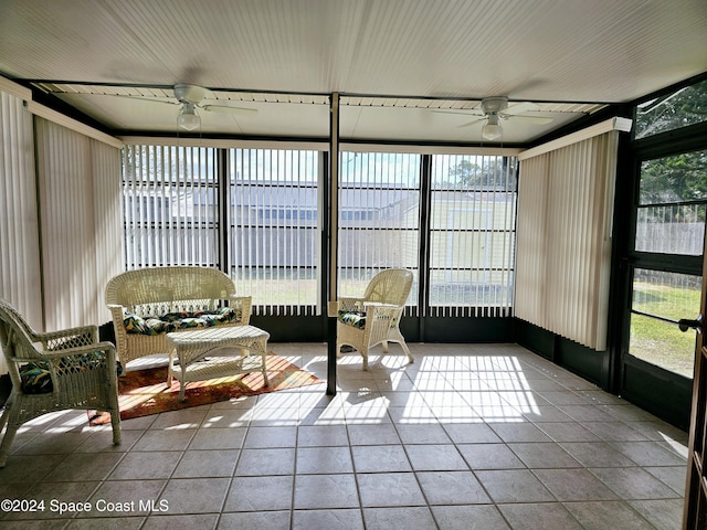 sunroom / solarium with ceiling fan and a healthy amount of sunlight