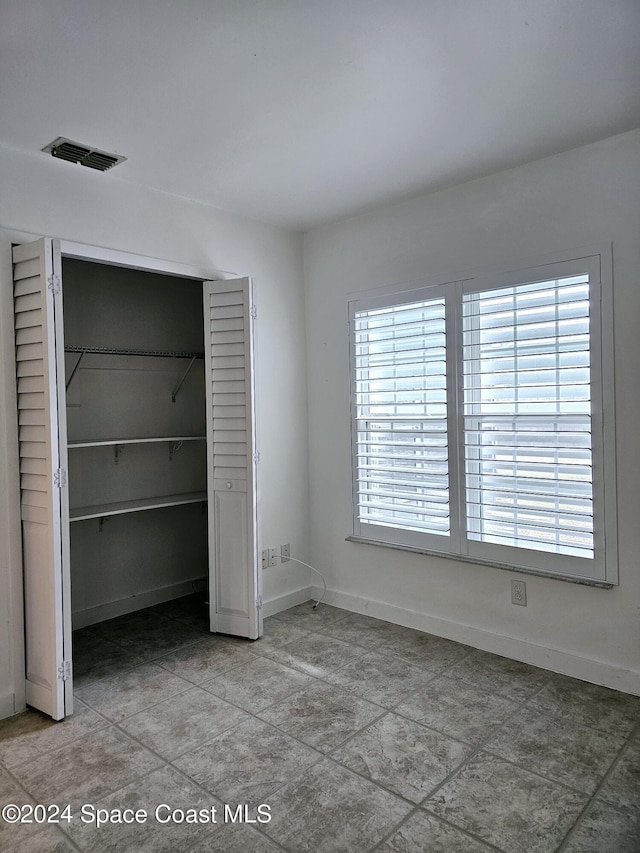 unfurnished bedroom featuring a closet