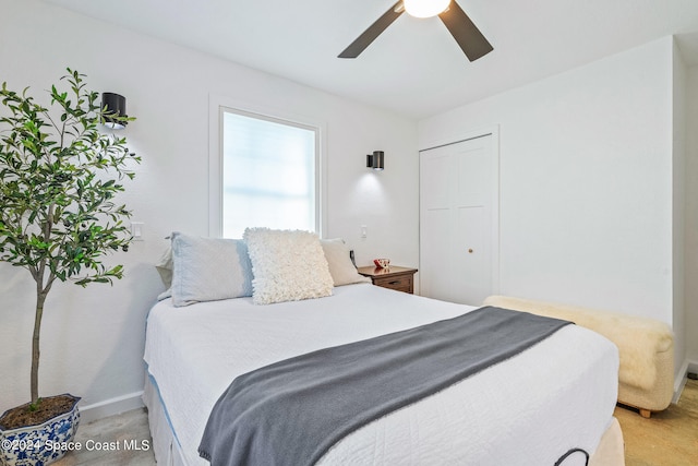 bedroom featuring light carpet, a closet, and ceiling fan