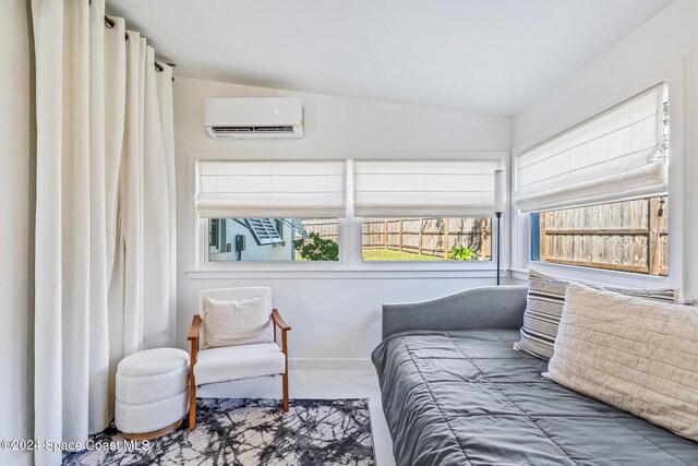 154 21st St SW, Vero Beach, FL 32962 - bedroom with baseboards, vaulted ceiling, and a wall unit AC