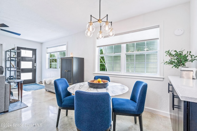 dining room with a textured ceiling and ceiling fan with notable chandelier