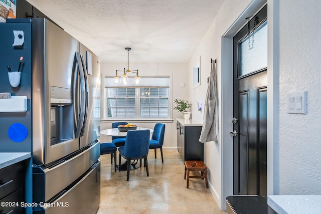 kitchen featuring a notable chandelier, a textured ceiling, stainless steel fridge with ice dispenser, and decorative light fixtures