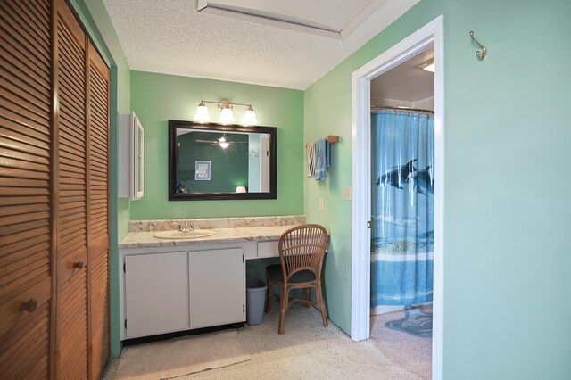 bathroom featuring vanity, a shower with curtain, and a textured ceiling