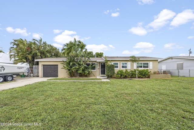 ranch-style house featuring a front lawn, concrete driveway, fence, an attached garage, and stucco siding