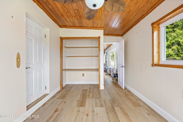 hallway featuring light hardwood / wood-style floors, crown molding, and wooden ceiling