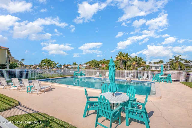 community pool featuring a patio area and fence
