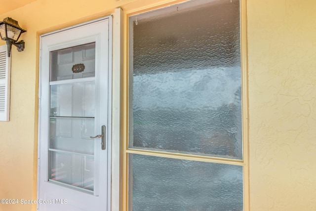 doorway to property with stucco siding