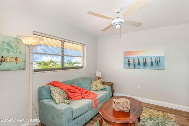 sitting room with wood finished floors, baseboards, and ceiling fan