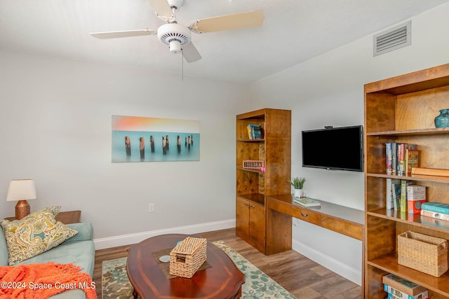 living area featuring ceiling fan, baseboards, visible vents, and wood finished floors