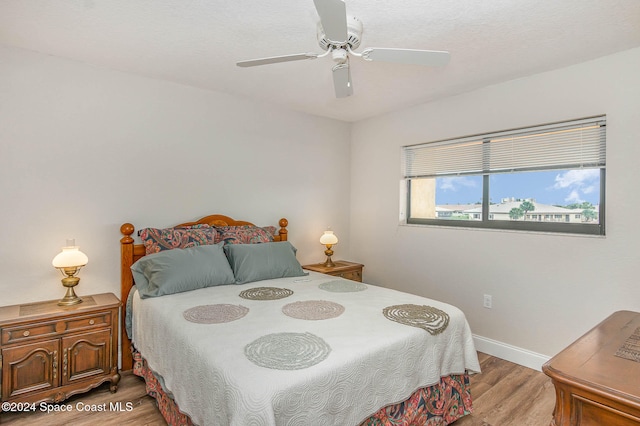 bedroom featuring light hardwood / wood-style flooring and ceiling fan