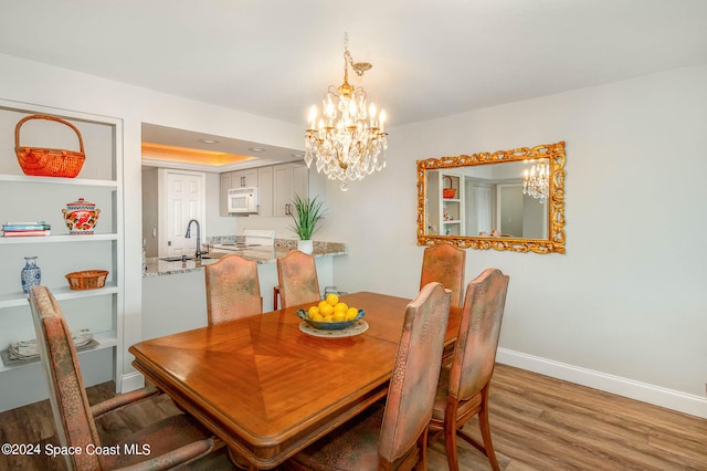 dining room featuring wood-type flooring and sink