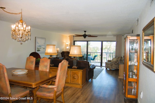 dining room featuring ceiling fan with notable chandelier, visible vents, and wood finished floors